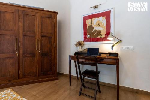 a room with a desk with a laptop on it at StayVista at Samara - 4BR with Pool & River View in Pālghar