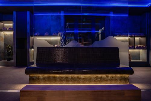 a bench in a room with blue lights at Viale Boutique Hotel in Villány