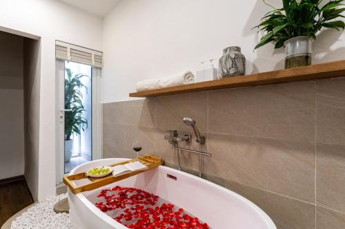 a bathroom with a tub filled with red liquid at HanoianHearths - FamilyReunion- Projector- Bathtub in Hanoi