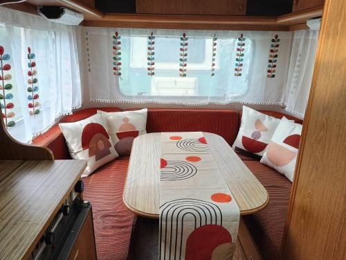 a small room with a table and pillows in it at Ecoglamping Tramonti in Tramonti