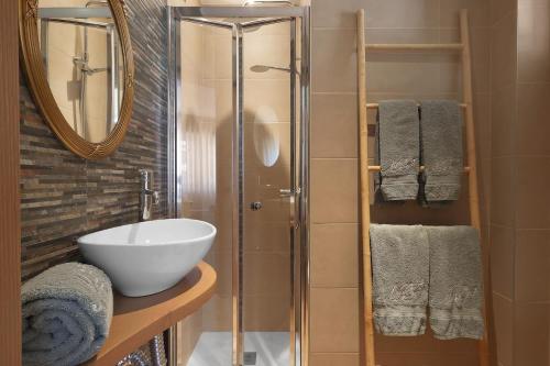 a bathroom with a sink and a glass shower at Vintage Copio Apartment in Vila Nova de Gaia