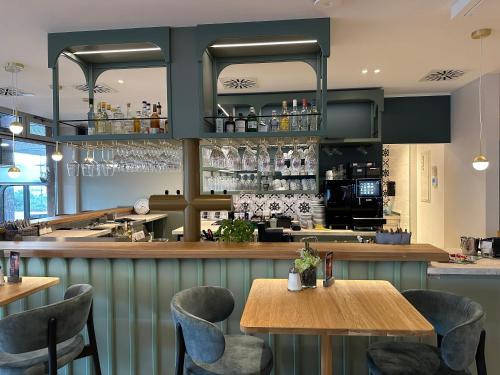 a restaurant with two tables and a bar at Hotel Am Markt Nordenham in Nordenham