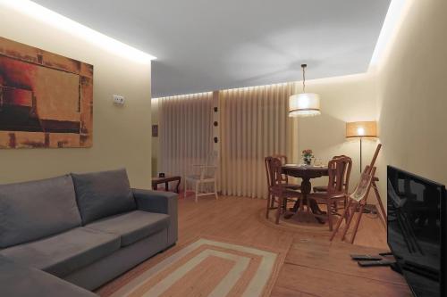 a living room with a couch and a table at Vintage Copio Apartment in Vila Nova de Gaia
