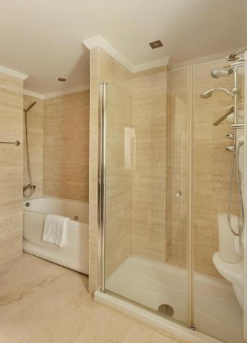 a bathroom with a shower and a bath tub at Green Haven Casares in Casares