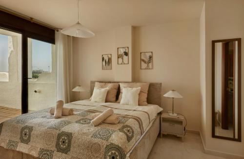 a bedroom with a large bed and a large window at Green Haven Casares in Casares