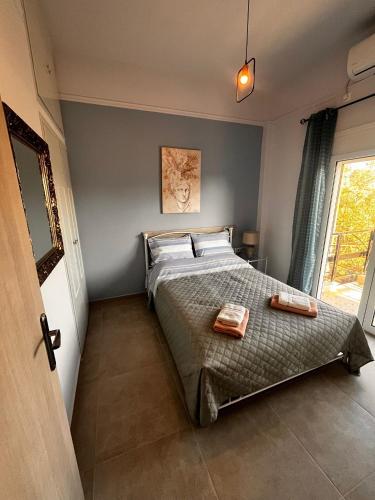a bedroom with a bed with two towels on it at Marys Home Eretria in Malakóndas