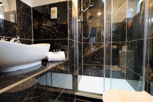 a bathroom with a sink and a shower at Kites House Long Stays Sleep 8 Free Parking and WI-FI in Bristol