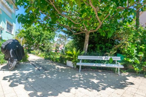 a bike parked next to a bench next to a tree at Apartments Katarine Zrinske in Vodice