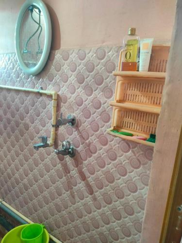 a bathroom with a sink and a mirror at Sarojinilaya Homestay in Guwahati