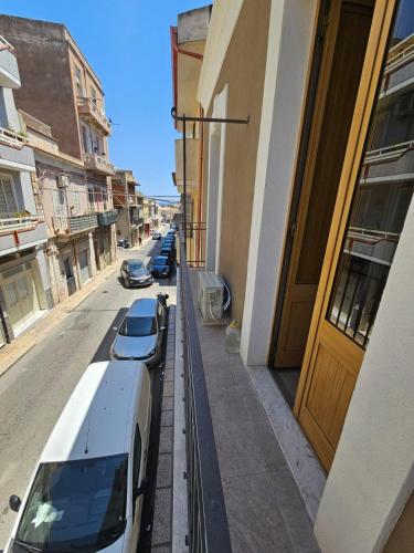 a white car parked on a street next to a building at Cavour Apartaments in Pachino