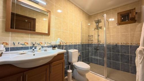 a bathroom with a sink and a toilet and a shower at Casa Villa By Kirte in Eceabat