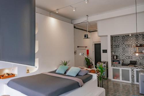 a bedroom with a large bed with blue pillows at Saigon Hideout New World View in Ho Chi Minh City