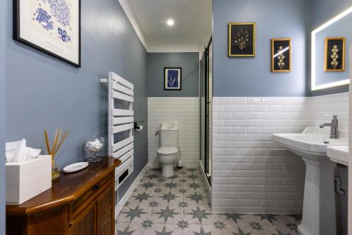 a bathroom with a toilet and a sink at H de Surgères in Surgères