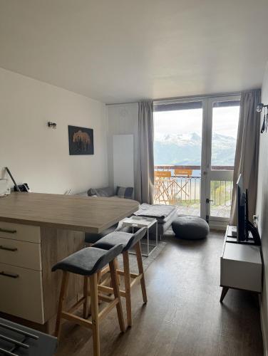 Habitación con escritorio y cama con vistas. en ARC 2000, Studio rénové 4 couchages, Vue Montagne, en Arc 2000