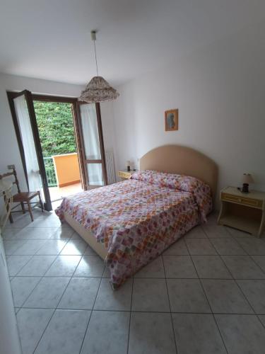 a bedroom with a bed and a large window at Simone 2C in Marcelli di Numana