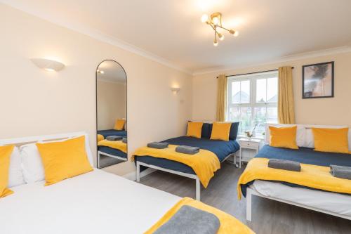 a bedroom with two beds and a mirror at Open Mind Property -2 Bedrooms with FREE parking in Bournemouth