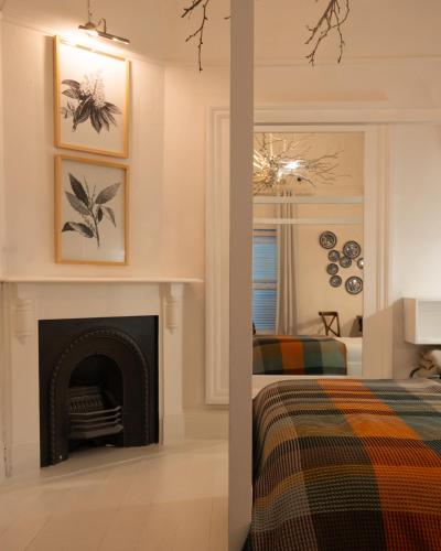 a bedroom with a fireplace next to a bed at Boutique Guesthouse Hanover in Hanover