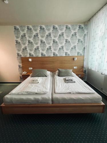 a bedroom with two twin beds in a room at Hotel Vacek Pod Věží in Hradec Králové