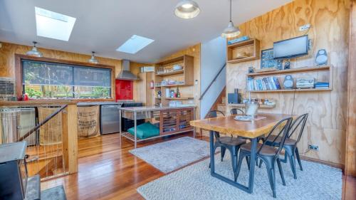 a kitchen with a table and chairs in a room at Rangi Terrace Views in Karikari Peninsula