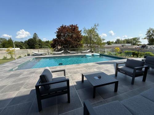a swimming pool with two chairs and a table at Aura Castle in Picquigny