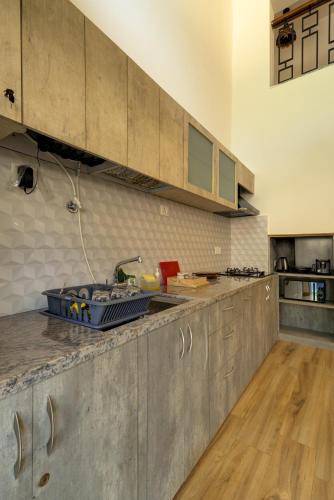 a kitchen with a sink and a counter top at Casa Avasa - 3bhk Private Pool Villa in Siolim in Camorlim
