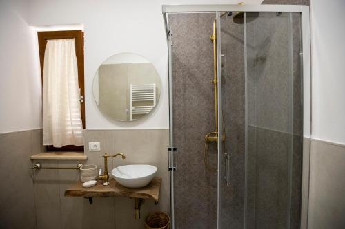 a bathroom with a shower with a sink and a mirror at Da MammaMimma in Cascia