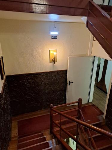 a staircase with a light on the wall of a building at Residencial Dom Duarte in Viseu