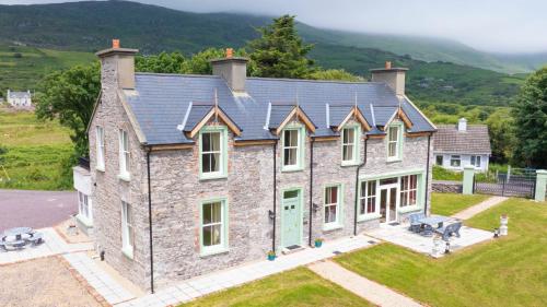 an aerial view of a stone house with a roof at Tobervilla Guest House in Caherdaniel