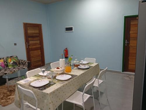 a table with plates of food on it in a living room at iruka guesthouse in Bandara
