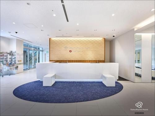 a meeting room with a large screen in a building at Daiwa Roynet Hotel Numazu in Numazu