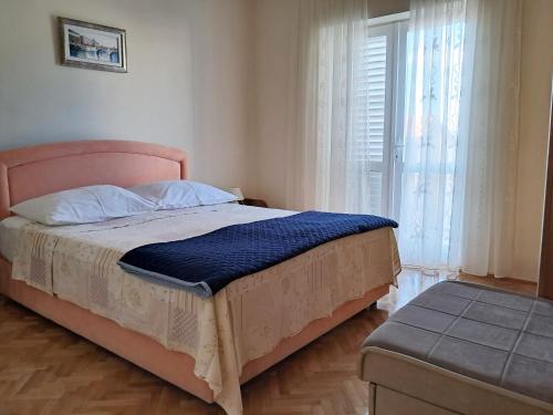 Postel nebo postele na pokoji v ubytování Apartments Melinda