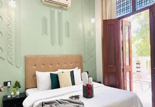 a bedroom with a bed and a door to a patio at BluO Awesome 1BHK DLF Galleria Market ,Gym TT in Gurgaon