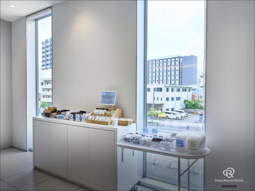 a room with a counter and a large window at Daiwa Roynet Hotel Numazu in Numazu