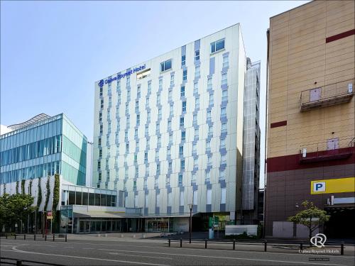 a large building with glass windows on a city street at Daiwa Roynet Hotel Numazu in Numazu