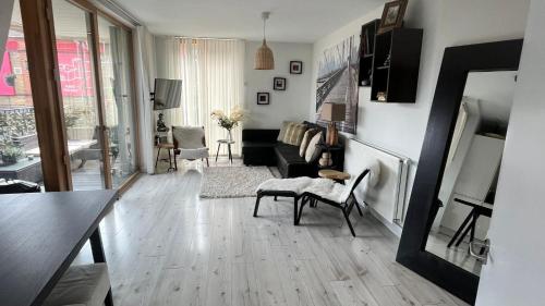 a living room with a couch and a table at Notting Hill 2-Bed Apt with Balcony 1 min to Tube in London