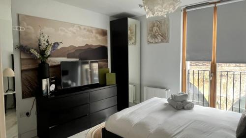 a bedroom with a teddy bear sitting on a bed at Notting Hill 2-Bed Apt with Balcony 1 min to Tube in London