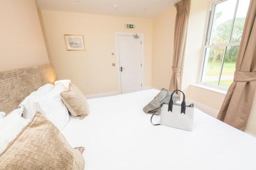 a bedroom with a bed with a purse on it at Tobervilla Guest House in Caherdaniel