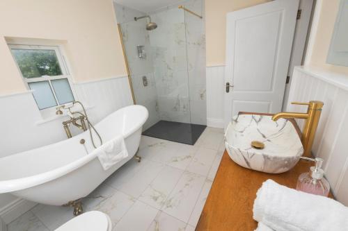 a bathroom with a large tub and a sink at Tobervilla Guest House in Caherdaniel