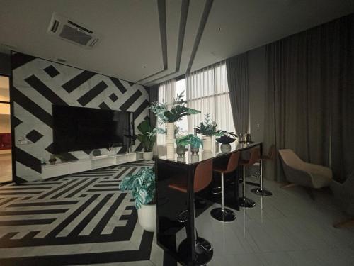 a living room with two tables and a flat screen tv at Nich Mono Ramkhumheng Low Rise in Sathani Ban Hua Mak