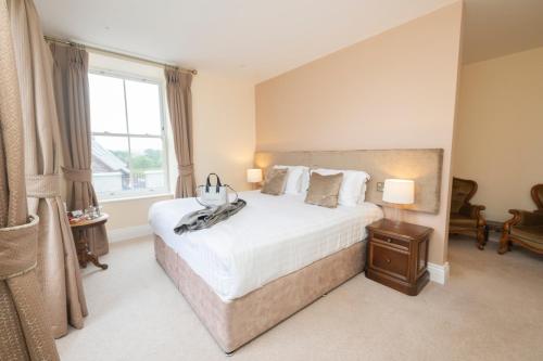 a bedroom with a large bed and a window at Tobervilla Guest House in Caherdaniel