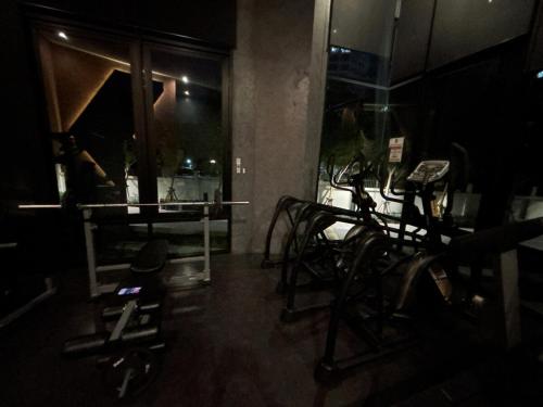a room with a gym with cardio equipment in it at Nich Mono Ramkhumheng Low Rise in Sathani Ban Hua Mak