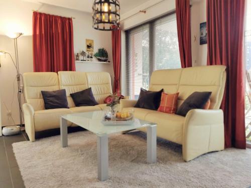 a living room with two couches and a coffee table at Ferienwohnung Granata 52 0S in Schillig