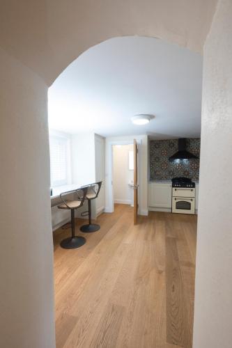 a living room with a table and a kitchen at Tobervilla Guest House in Caherdaniel