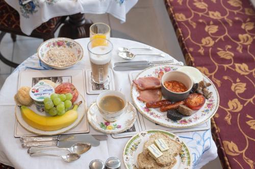 a table topped with plates of breakfast foods and drinks at Tobervilla Guest House in Caherdaniel