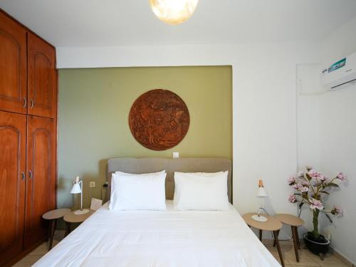 a bedroom with a large bed with two tables at Theodora Suite by Pegasus in Kardamaina