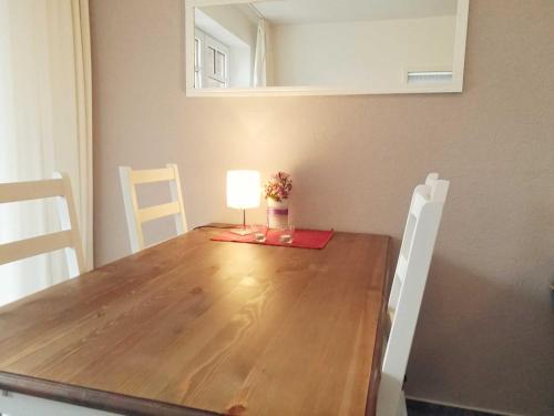 a dining room table with a lamp on top of it at Ferienwohnung Boje 7 in Schillig