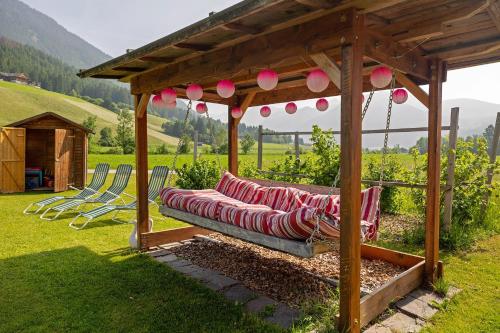 a couch under a gazebo in a yard at Untersinnerhof Gsies in Valle Di Casies