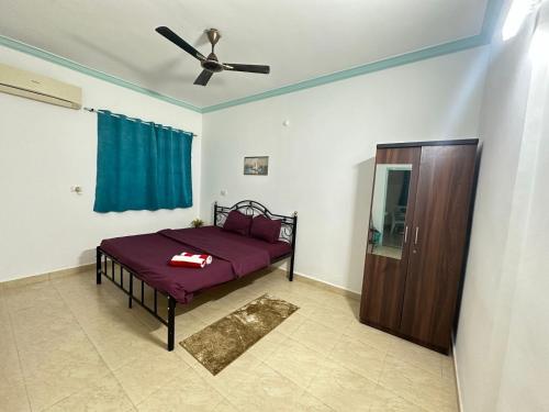 a bedroom with a bed and a ceiling fan at Backpack Travellers Hostel 500 per person -NonAC- 750 per person-AC in Colva