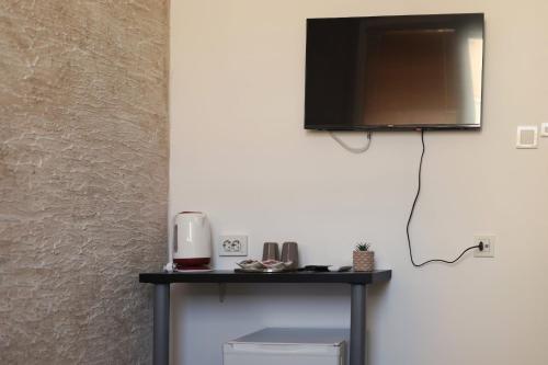 a flat screen tv hanging on a wall at Apartment Friends in Veles