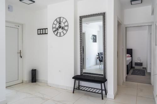 a mirror on a wall with a chair in a room at Villa DE Luna Istra,whirlpool in Barban